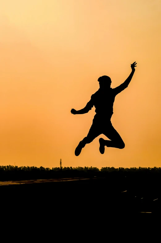 a silhouette of a man in the air