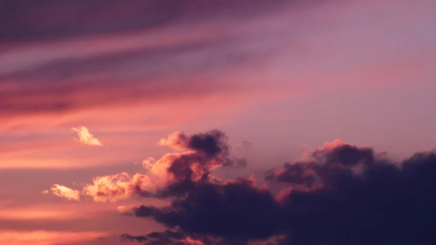 a red and purple sky at sunset over some trees