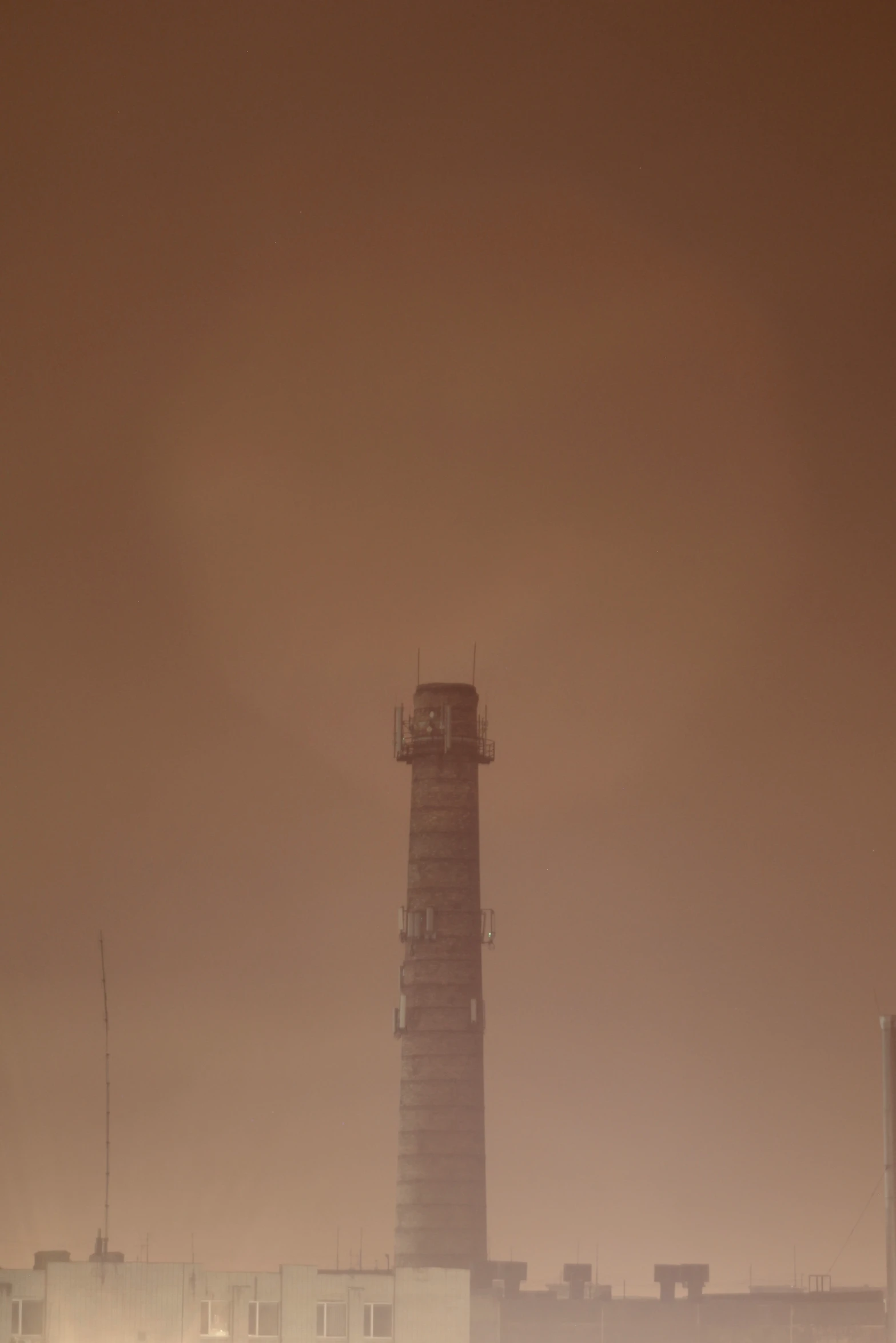 an orange and black po of a tower with a light house