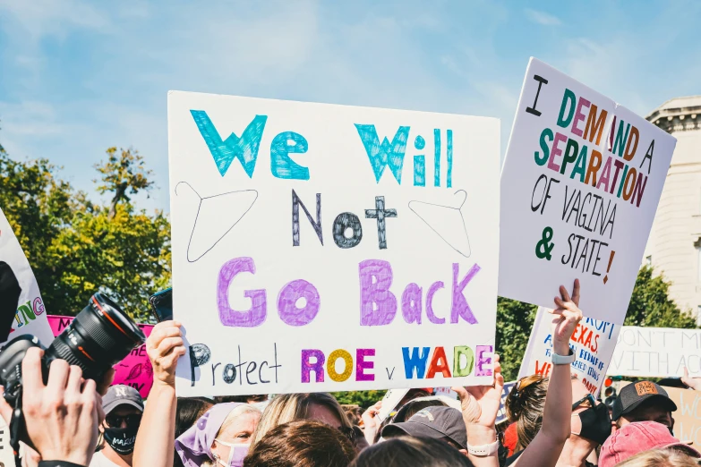 a protest in front of a group of people holding up signs