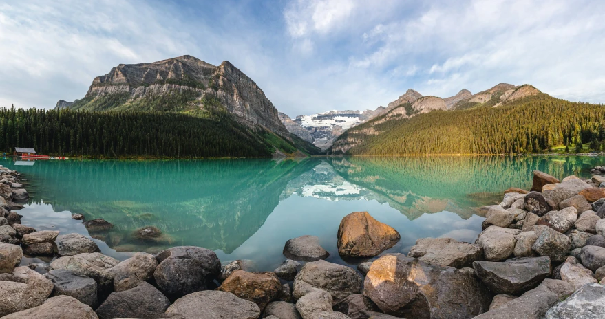 the beautiful lake is surrounded by mountains and green foliage