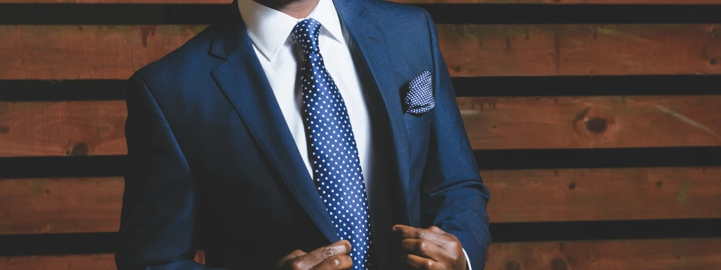 a man wearing a blue suit and white shirt