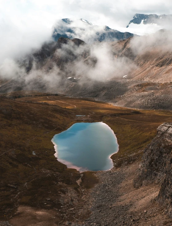 water surrounded by cloud, near a mountain range