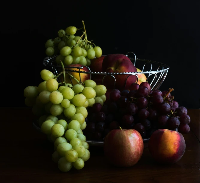 a bowl of gs and apples on a table