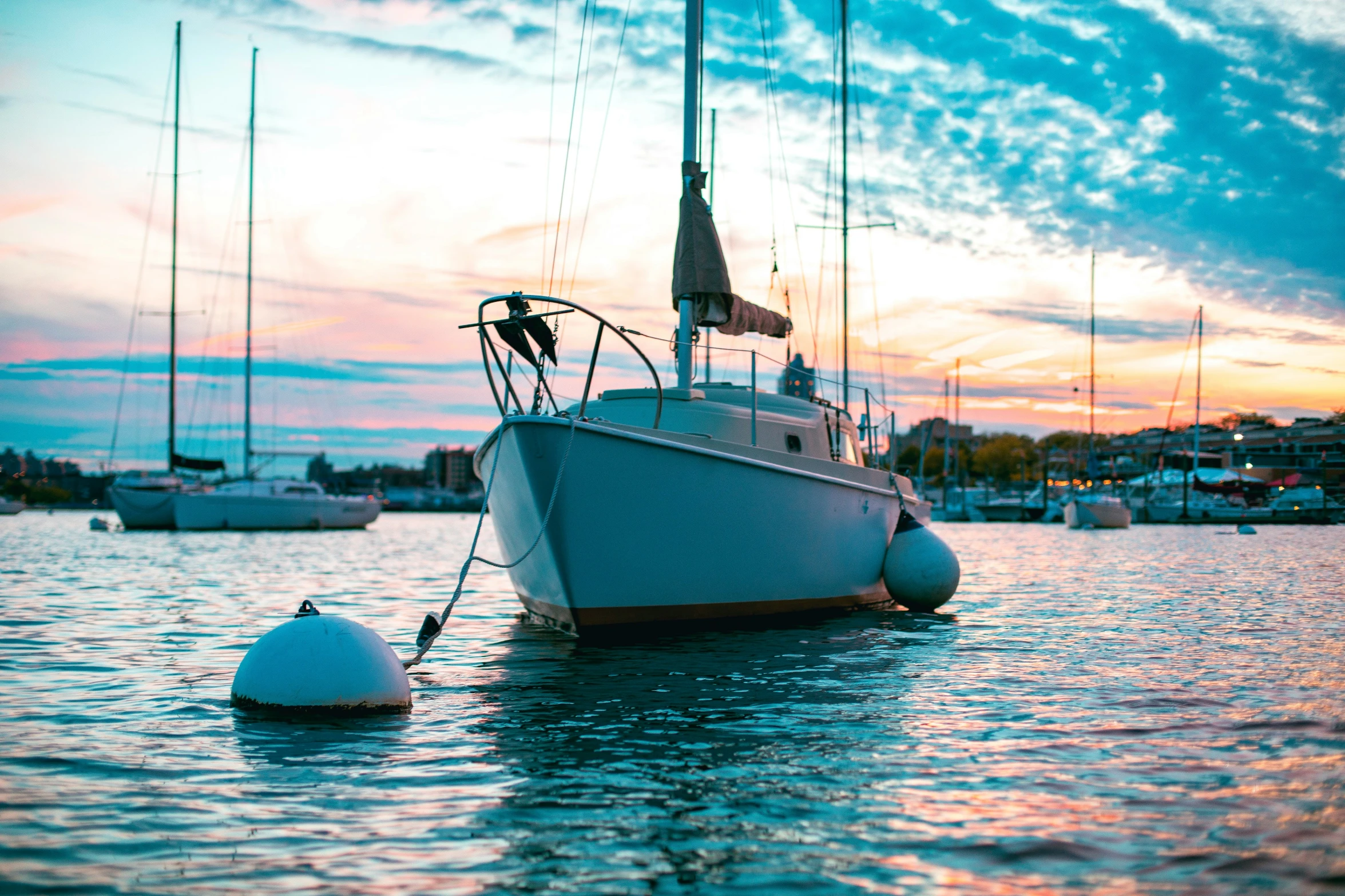 a boat floating in the water near a harbor