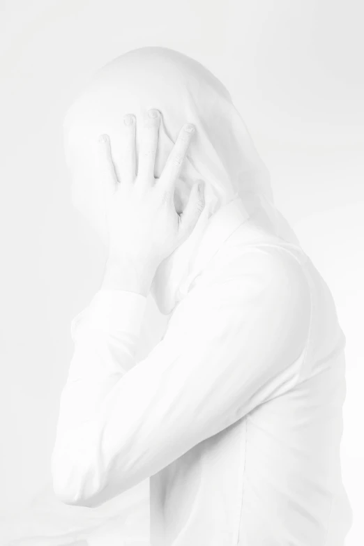 a man standing next to the camera, wearing a white shirt