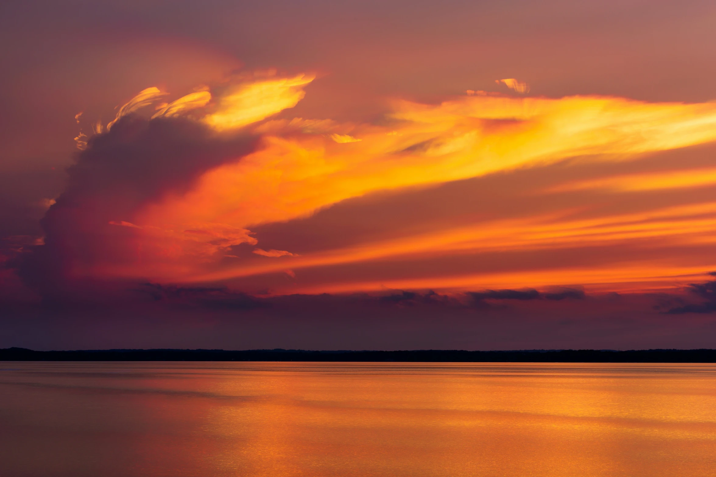 a large lake during a colorful sunset