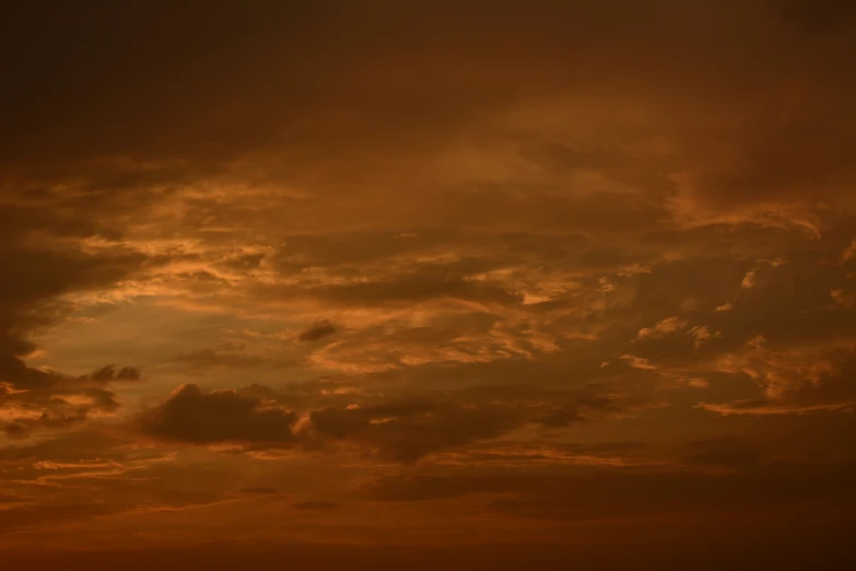 the sky is filled with clouds at sunset