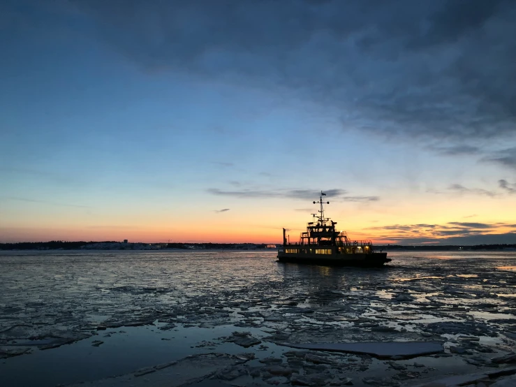 a boat floating on top of ice covered water