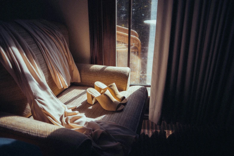 the shoes are left on and beside a couch