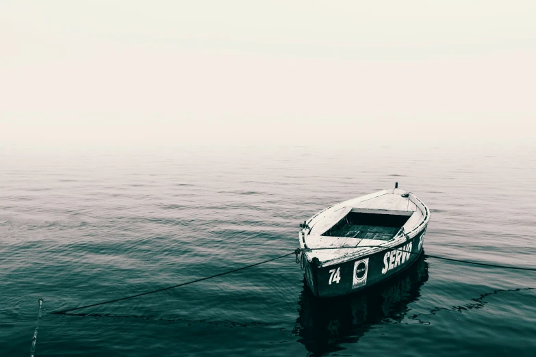 a small white boat floats in the water