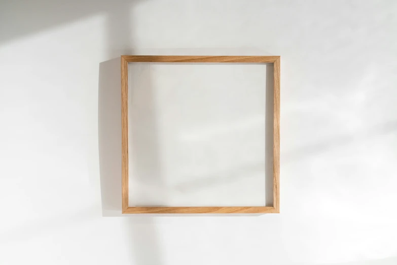 a wooden frame hanging on the wall above a white floor