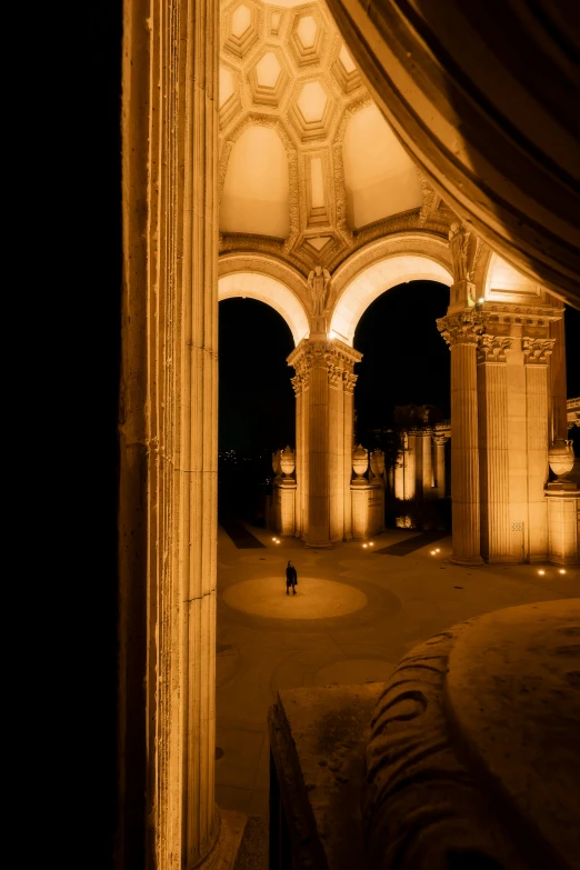 a person walking under a canopy at night