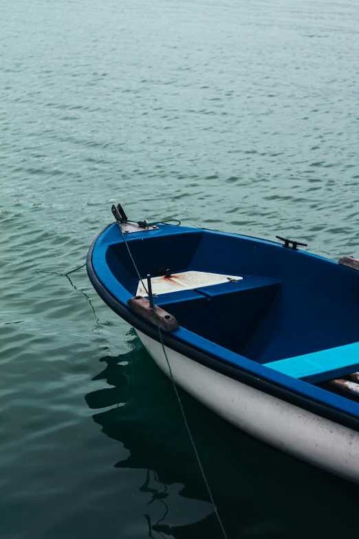 a blue and white rowboat in the water