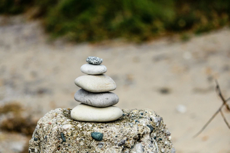 a stack of rocks is sitting on a beach