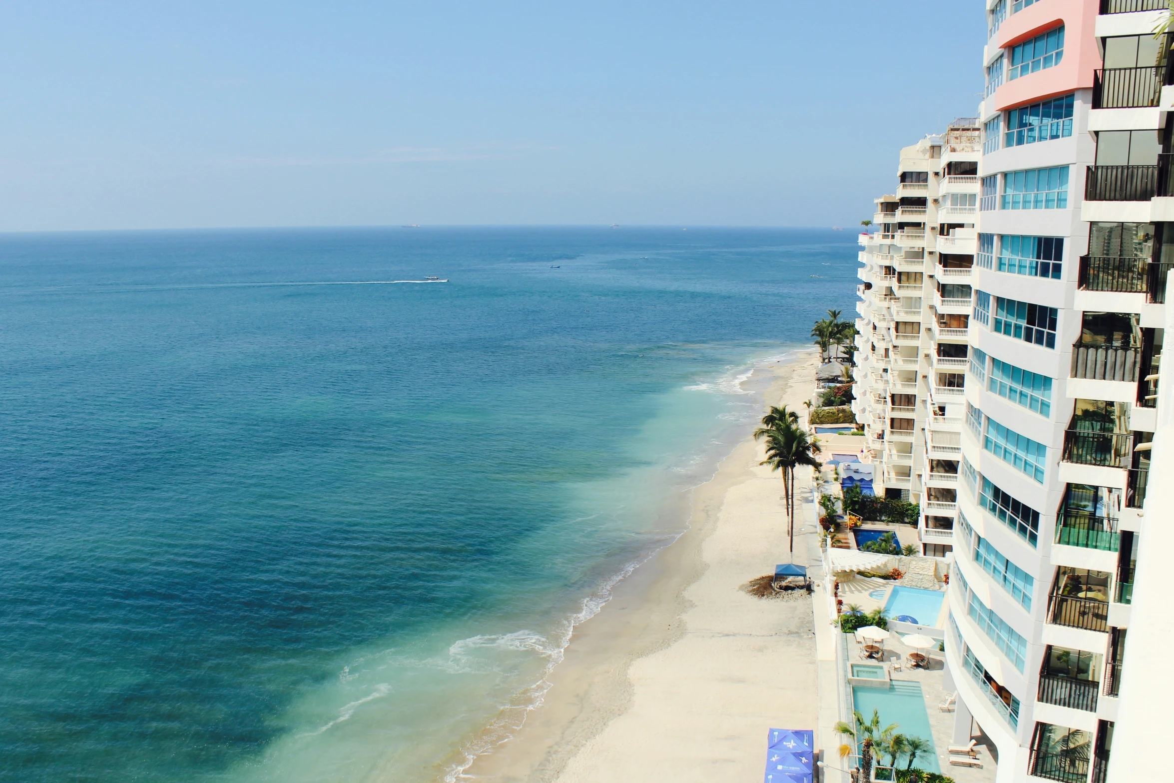 an aerial view of the shoreline of a beach resort