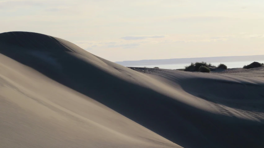a large sand dune with a person riding on top