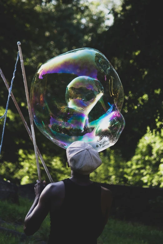 a woman is holding up bubbles while on a cell phone