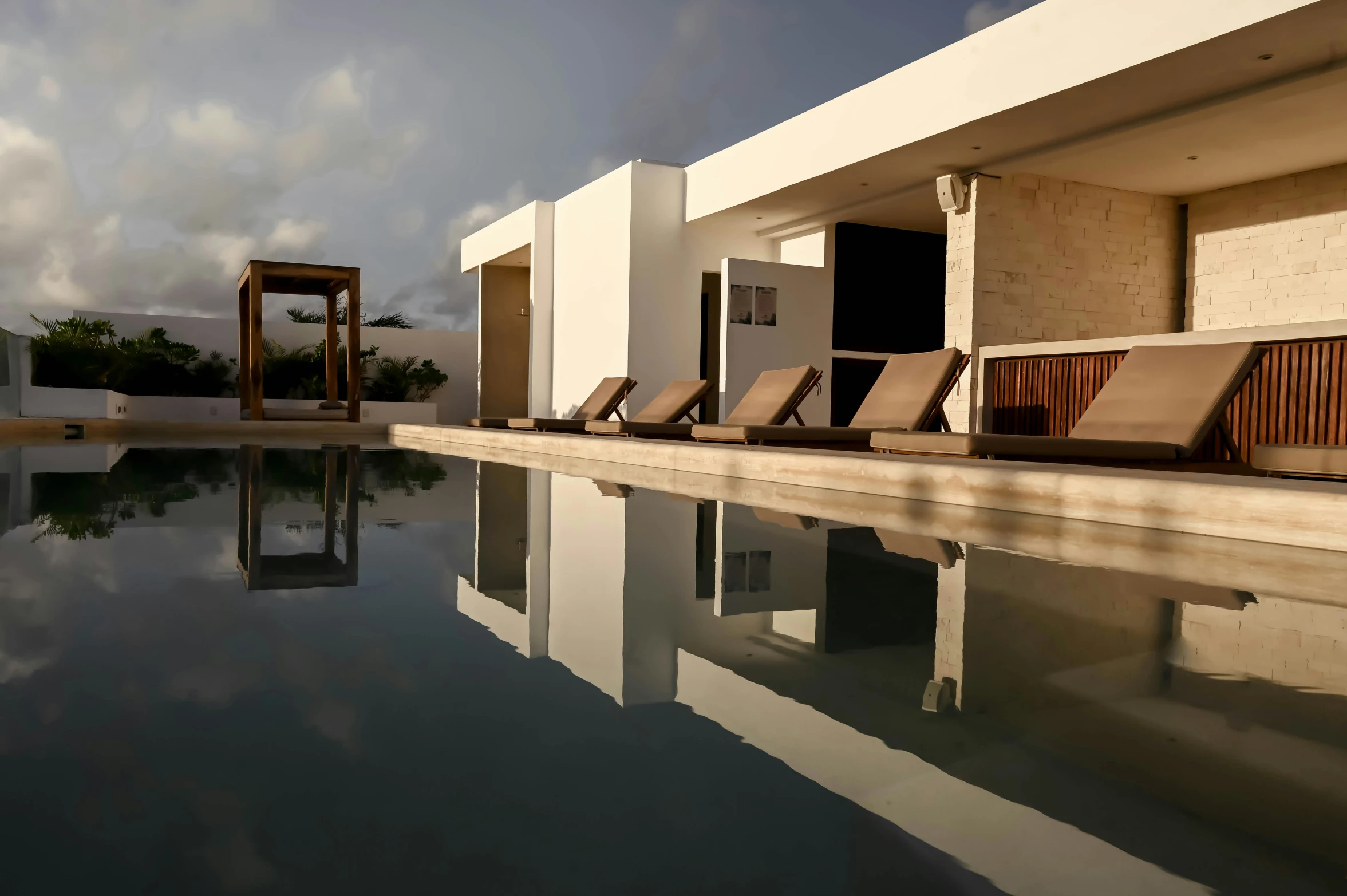 a row of chairs sitting on the side of a pool