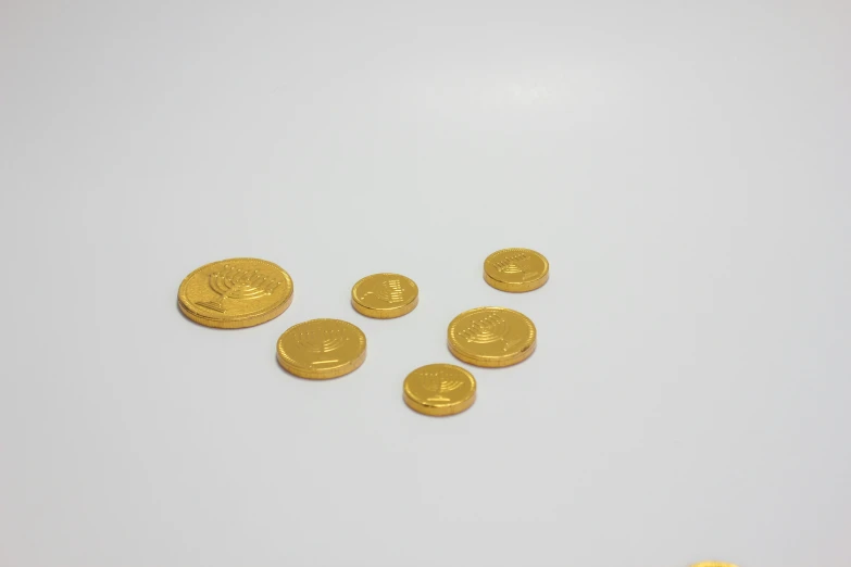 ten pieces of gold coin are laying beside them