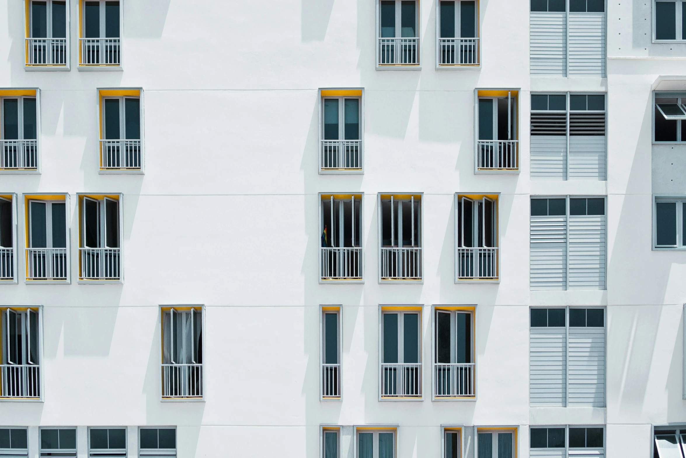 a tall building with many windows and white walls