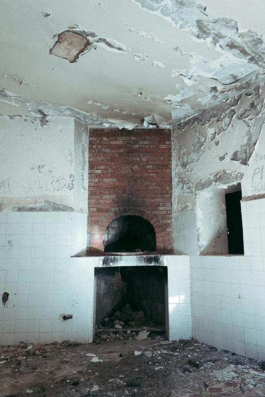 a kitchen in an old house, with some bricks removed