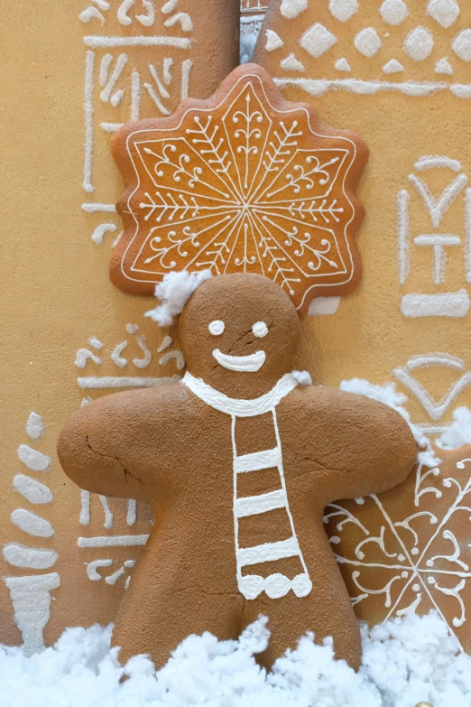 a gingerbread christmas decoration and a picture of a snow - covered ginger tree