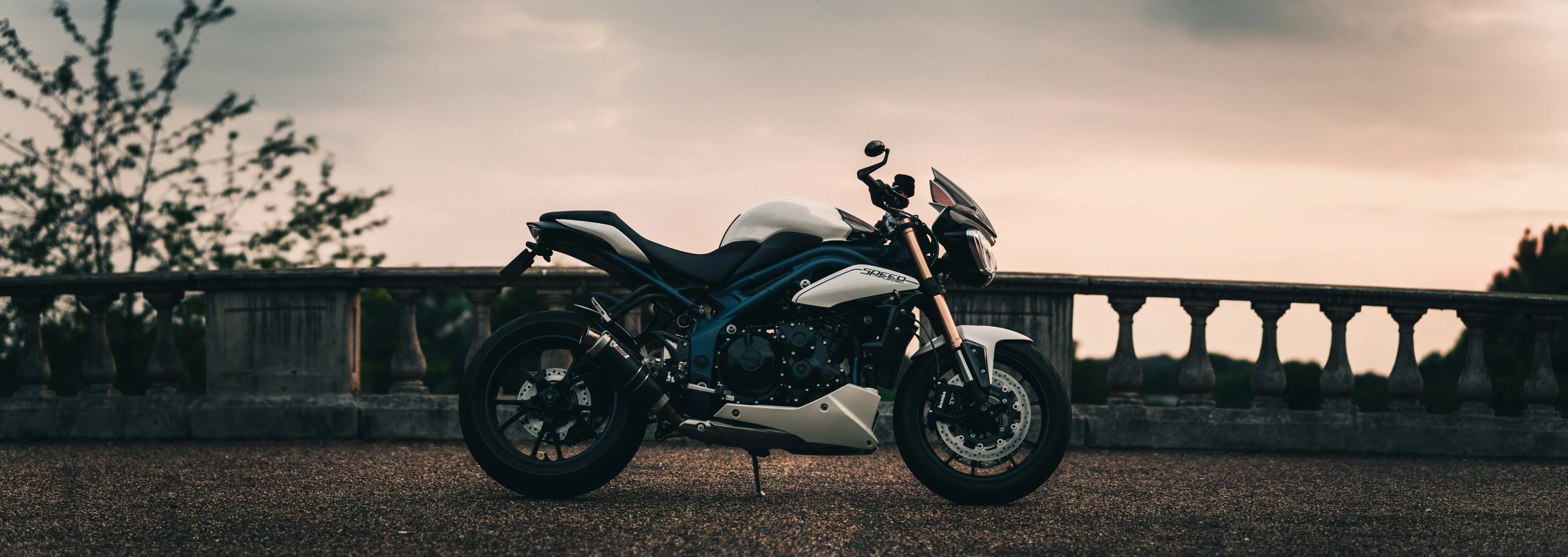 a motorcycle is parked in front of a stone wall