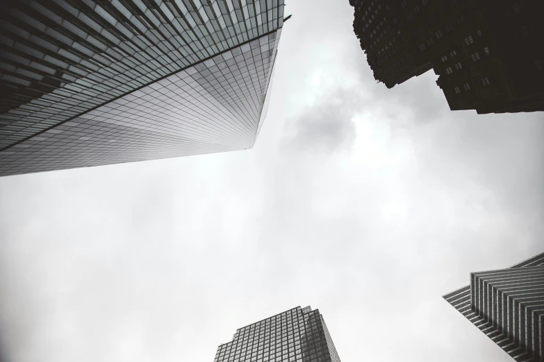 several tall buildings are shown up in the sky
