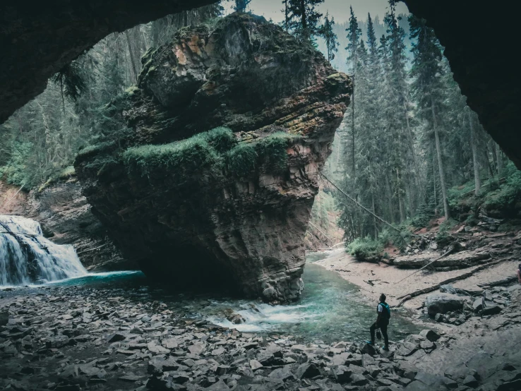 a person standing in the middle of a large stream