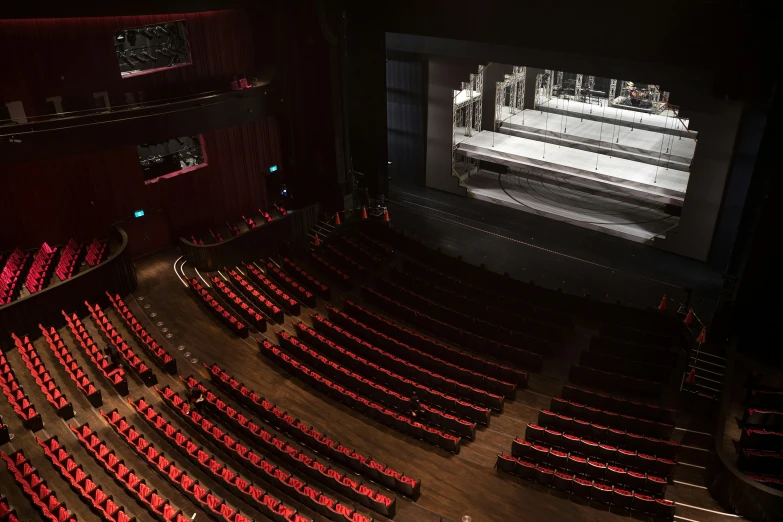 the theatre is empty but the chairs still have some seats