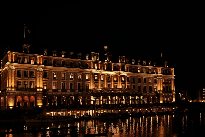 an old building illuminated up with many windows