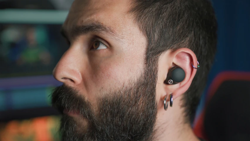 the man's earring is a piece of metal that has been placed in the back of his head