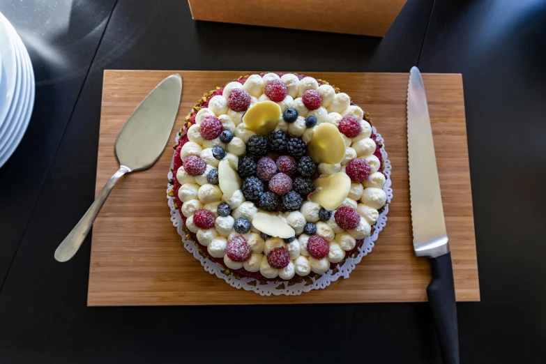 a cake with fruit in it is next to two forks