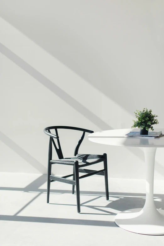 two chairs sitting at a small table that is white