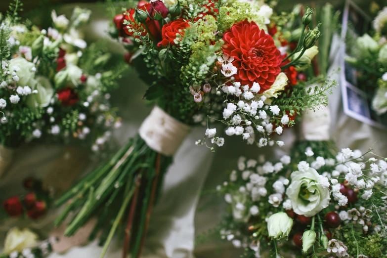 an array of wedding flowers are laid out on the table