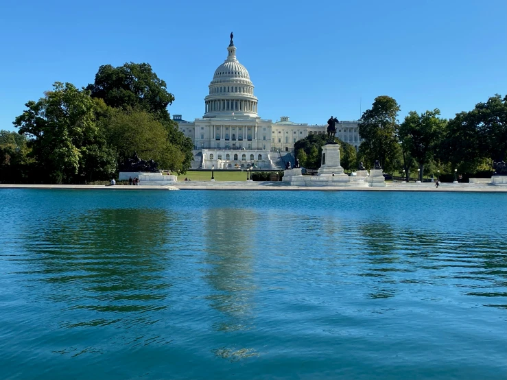 a government building next to a body of water