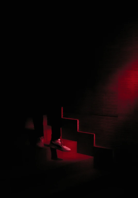 a black room with red lights from some stairs