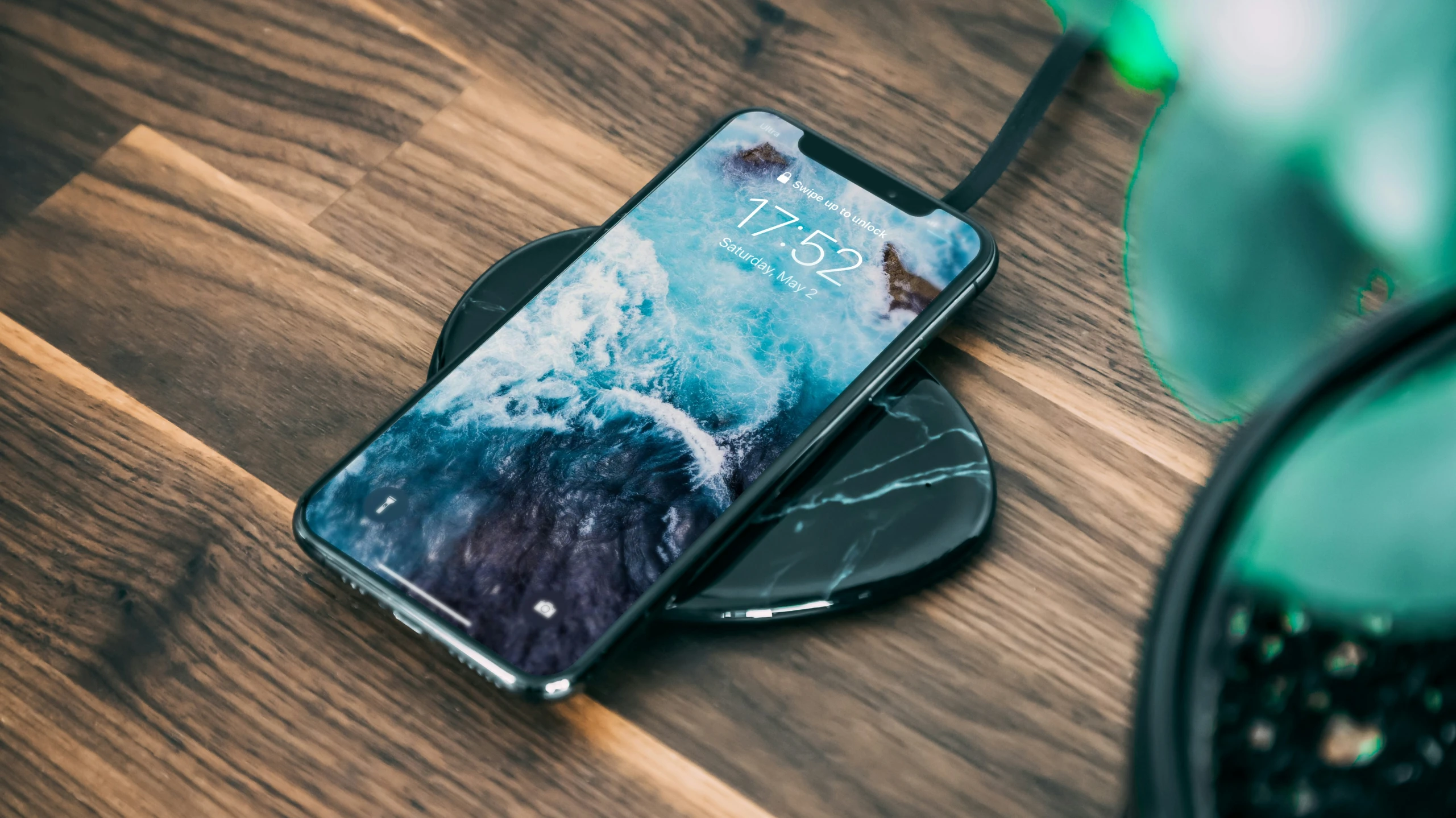 an iphone is shown on a table with ear buds