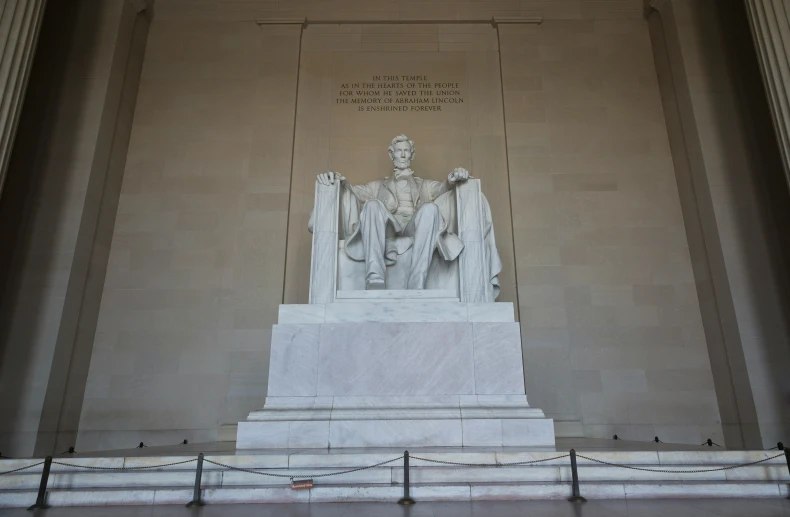 statue with writing on it in the background