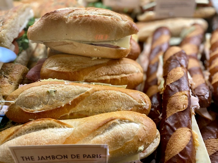 a large assortment of breads and other food in trays