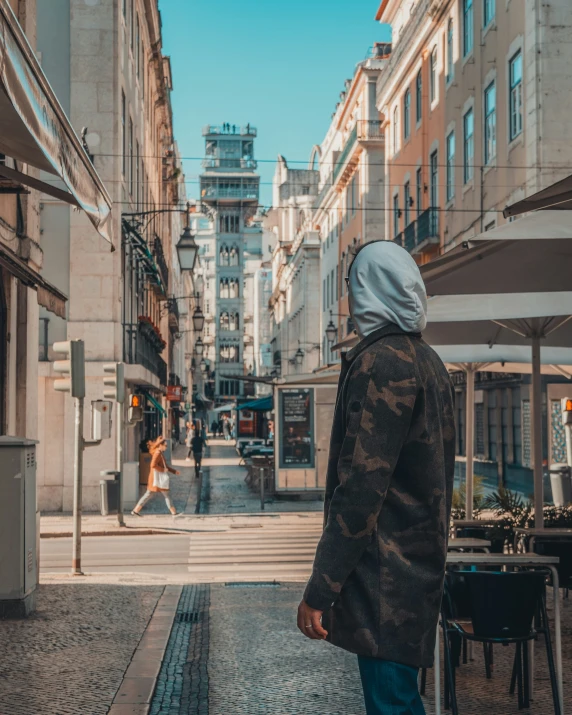 a person walking down a city street on a clear day