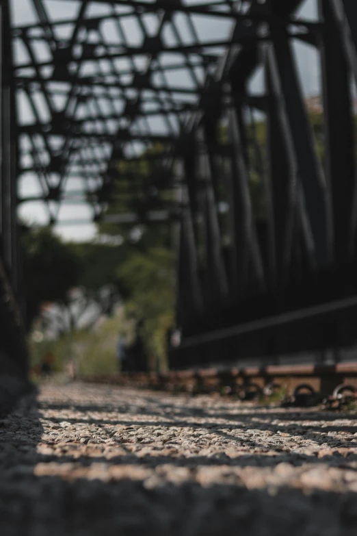 railroad tracks pass under an old rail bridge