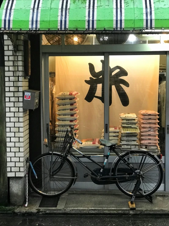 a bicycle is parked outside the window of a store