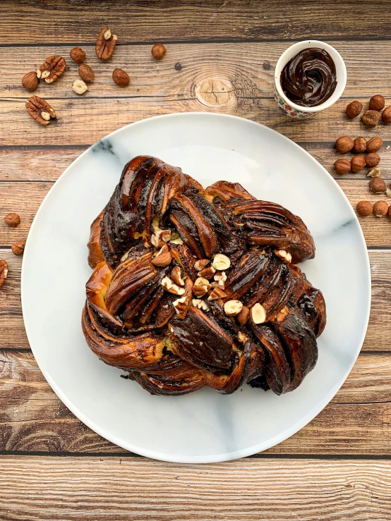 plate full of nutty pastry on wooden table