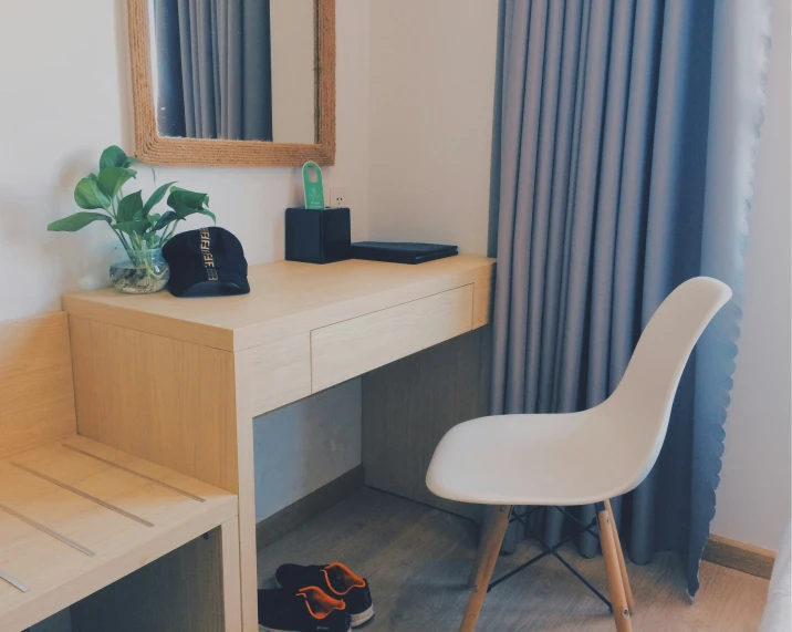 a desk with a mirror and chair and a desk lamp