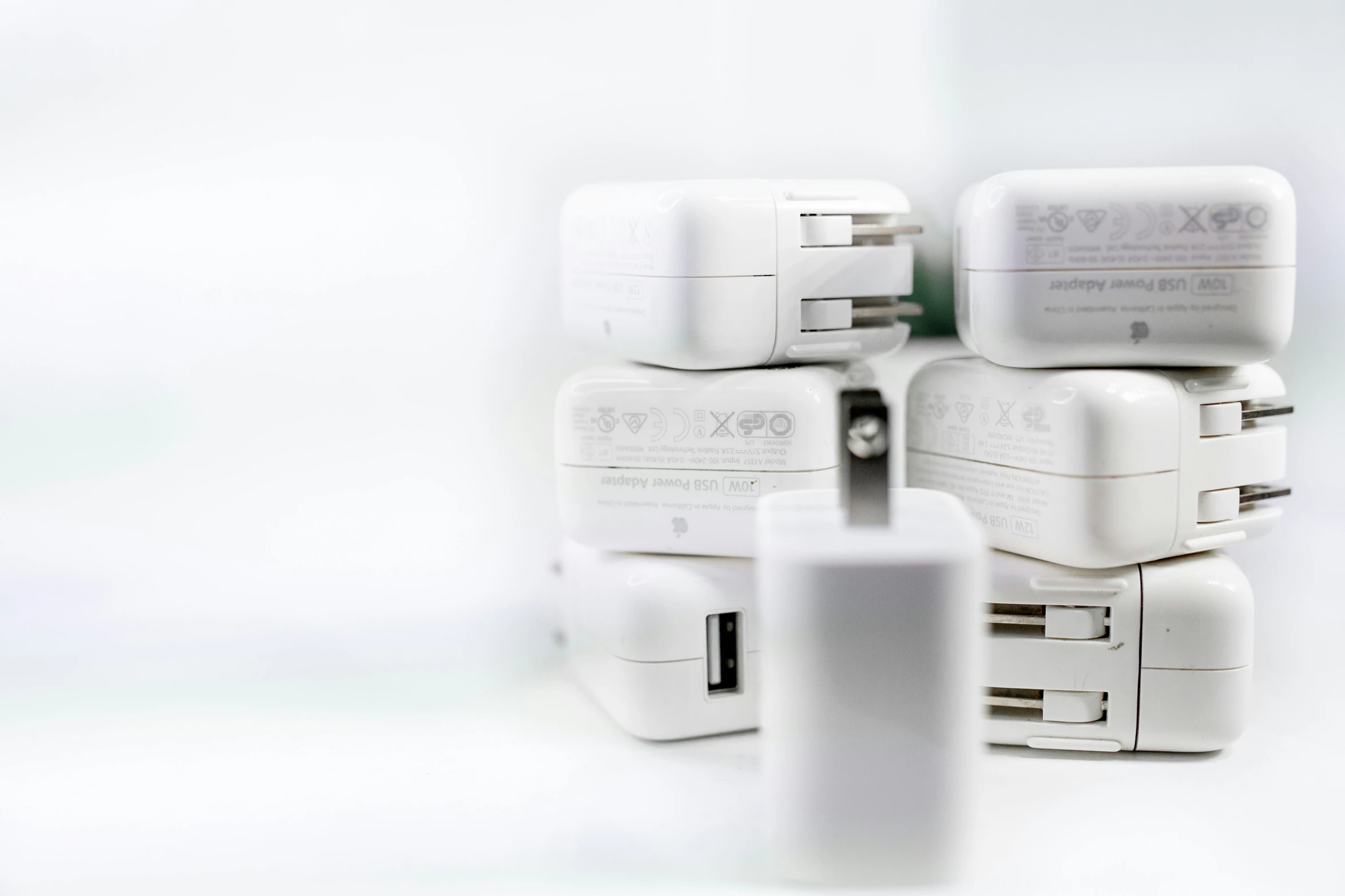 a stack of various white plugs are piled together