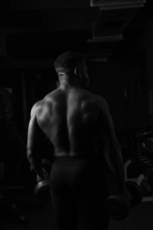 a man standing next to a gym machine