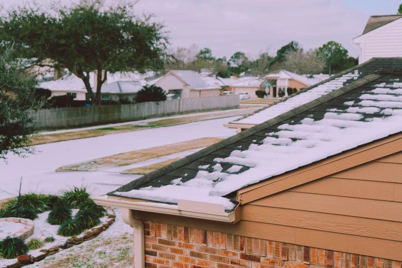 a snow covered roof and the top of a house