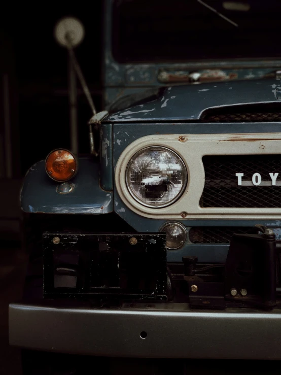 a close up of an old rusty blue car